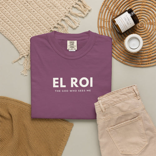 Berry El Roi Christian T-shirt with “The God Who Sees Me” typography, styled in a neutral flat lay.
