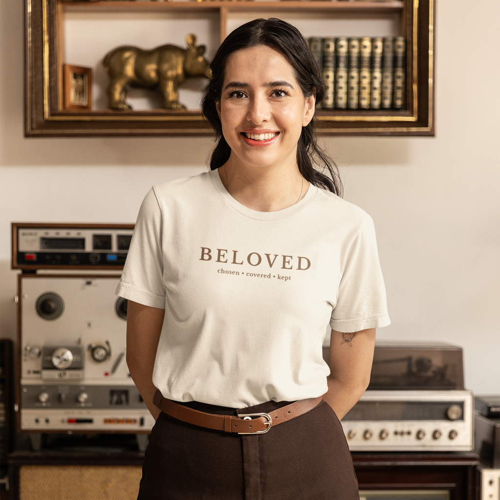Woman wearing natural Beloved Christian T-shirt with “Chosen • Covered • Kept” typography