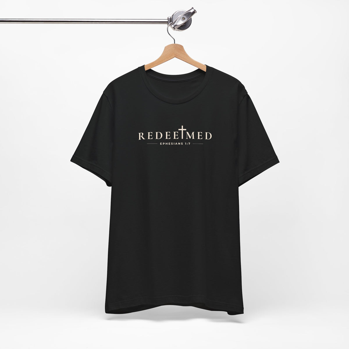 Black Redeemed Christian T-shirt with cross detail and Ephesians 1:7 typography on hanger