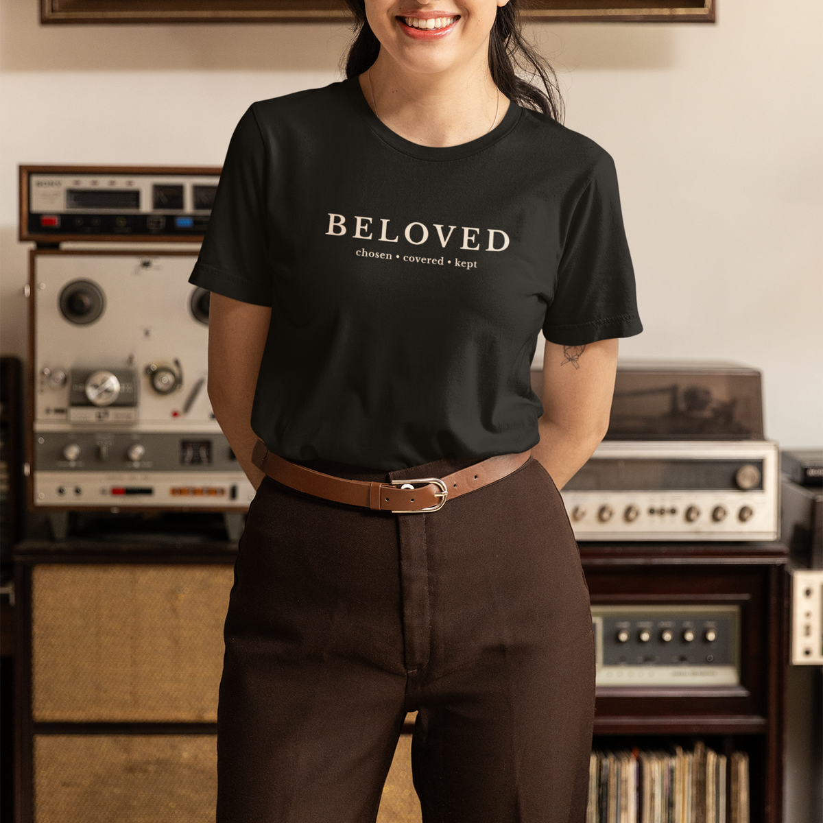 Woman wearing black Beloved Christian T-shirt with “Chosen • Covered • Kept” typography